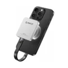 ORICO K20 Mini 2TB silver magnetic portable SSD on an iPhone, with magnetic mounting ring and flat USB-C cable